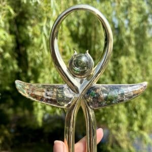 Glas sculptuur met spirale en vleugels, symboliseert spirituele energie.